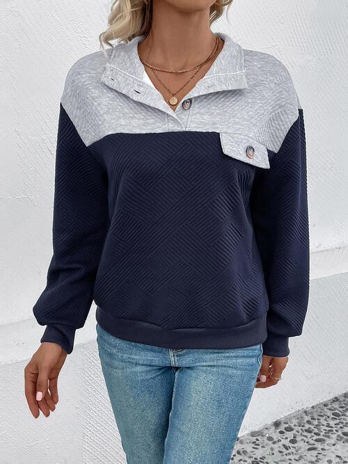 a woman wearing a blue and grey hoodie