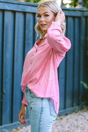 a woman in a pink shirt is posing for a picture