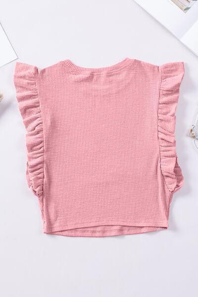 a pink top with ruffles on the shoulders