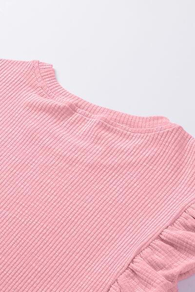 a pink top with ruffles on the bottom