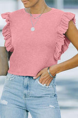 a woman wearing a pink top and ripped jeans