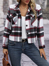 a woman wearing a plaid jacket and jeans