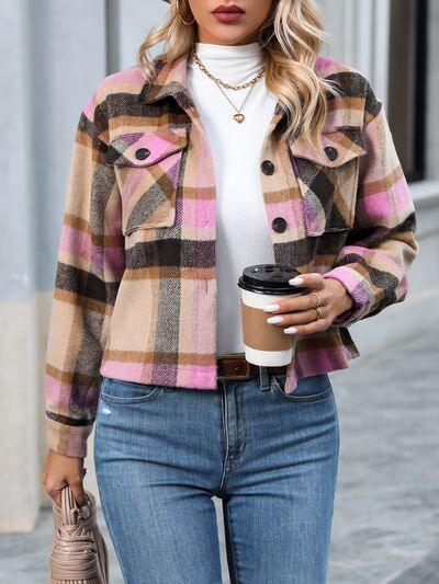 a woman in a plaid jacket holding a cup of coffee