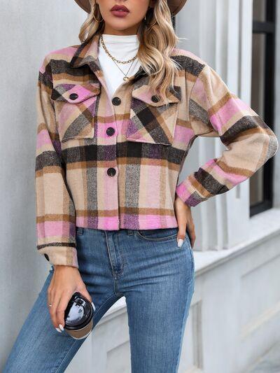 a woman wearing a plaid jacket and hat