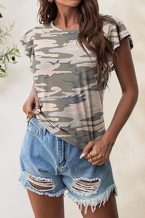 a woman wearing a camo t - shirt and denim shorts