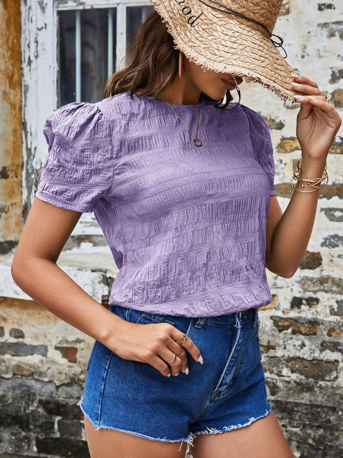 a woman wearing a straw hat and shorts