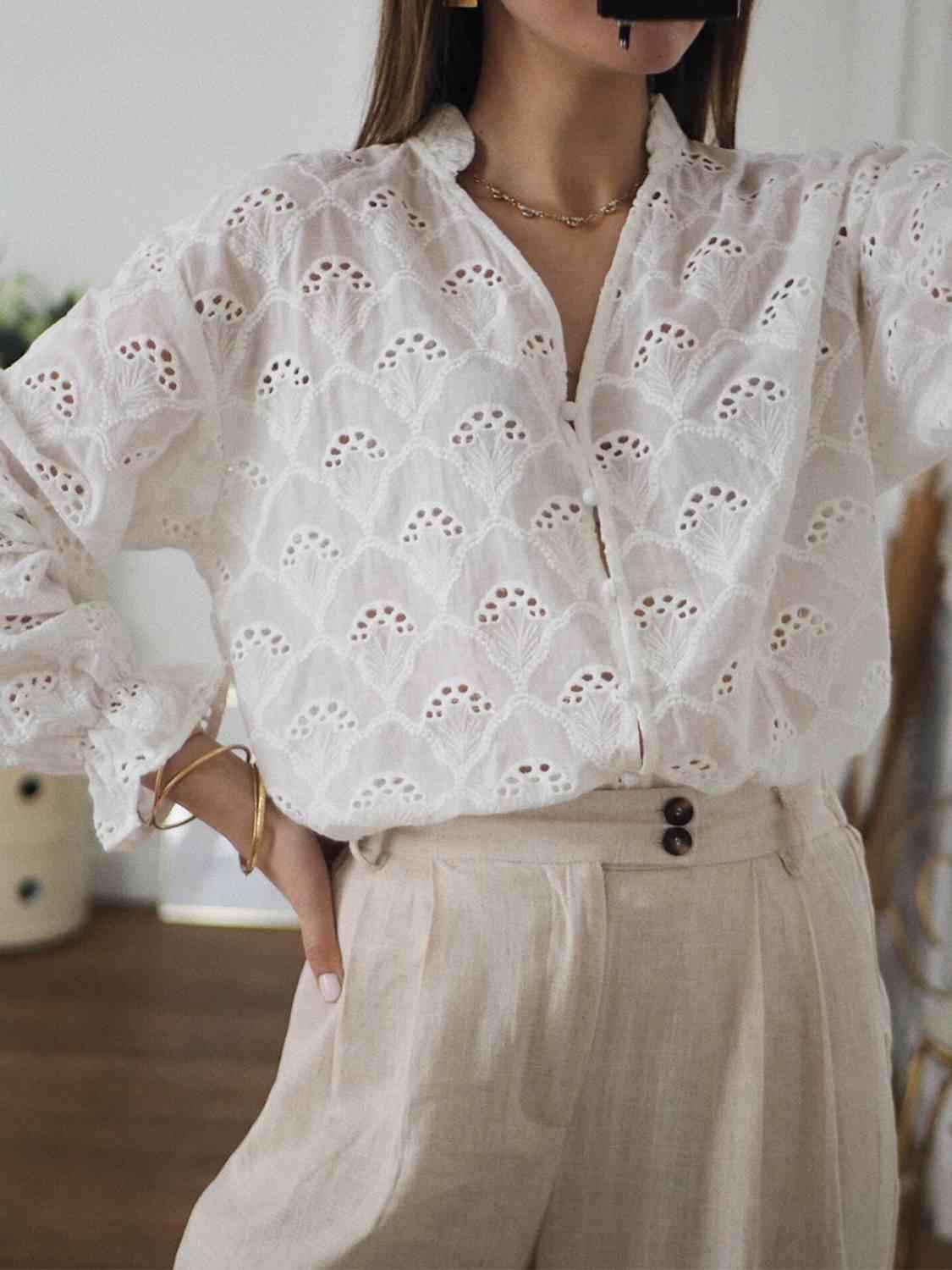 a woman wearing a white blouse and beige pants