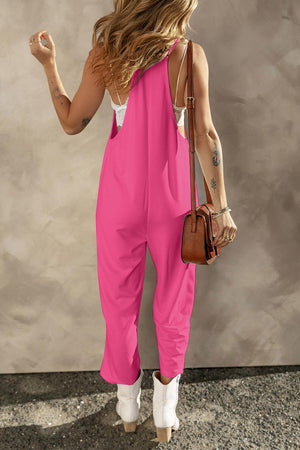 a woman in a pink jumpsuit with a handbag