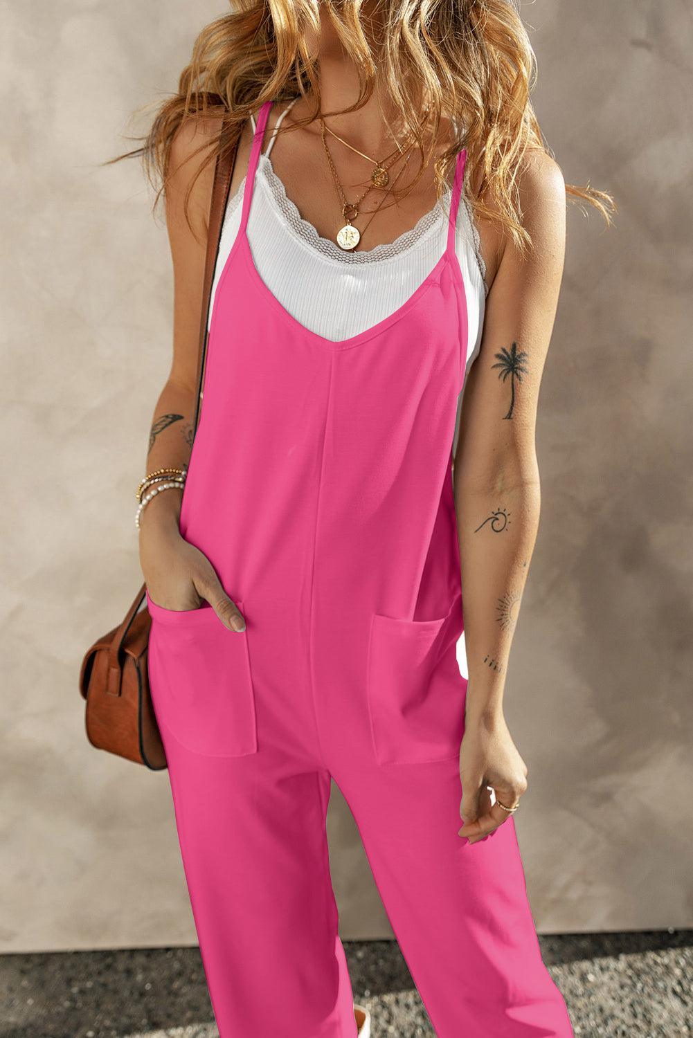 a woman wearing a pink jumpsuit and a white tank top