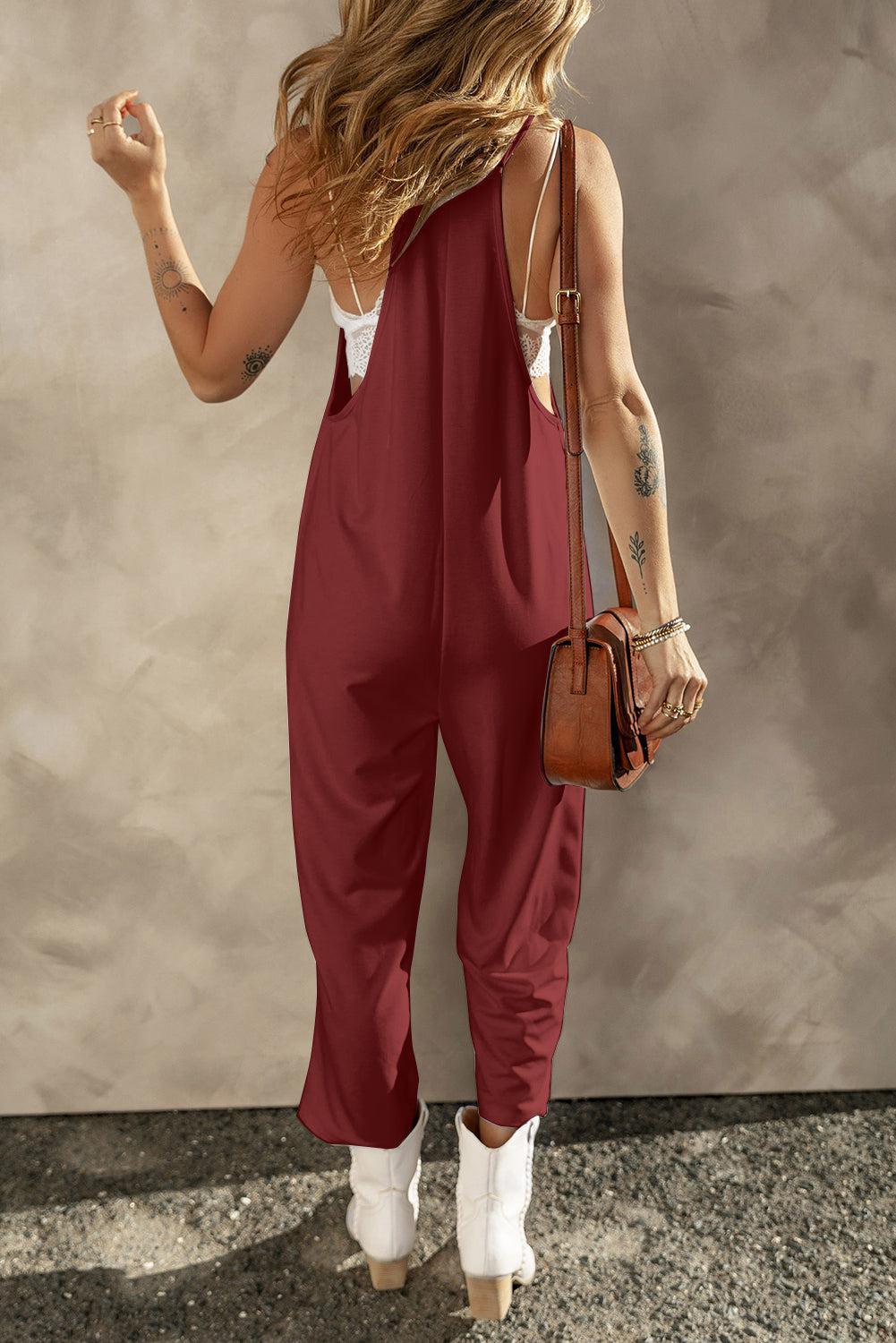 a woman wearing a red jumpsuit and white shoes