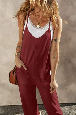 a woman wearing a red jumpsuit and a white tank top