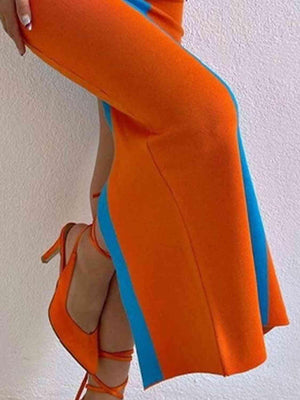 a woman in an orange dress and high heels