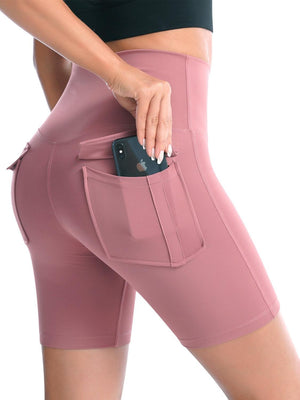 a woman in pink shorts with a cell phone in her pocket