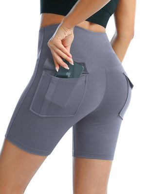 a woman in grey shorts holding a cell phone