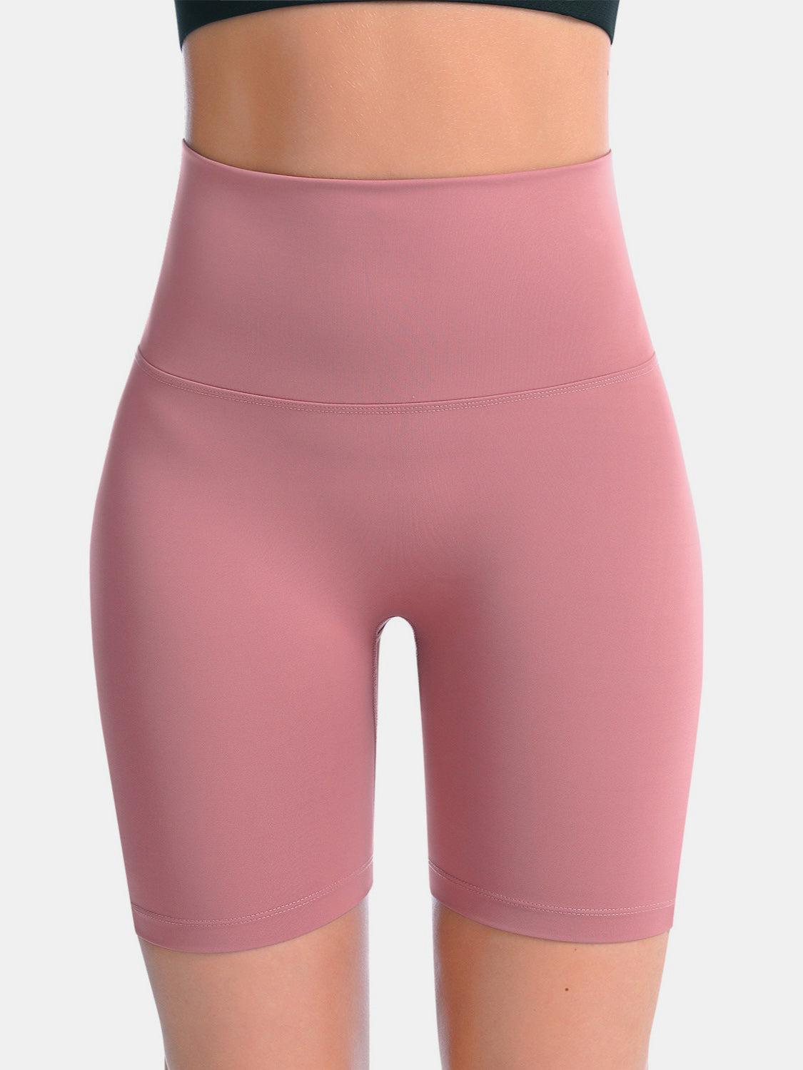 a close up of a woman wearing a pink shorts