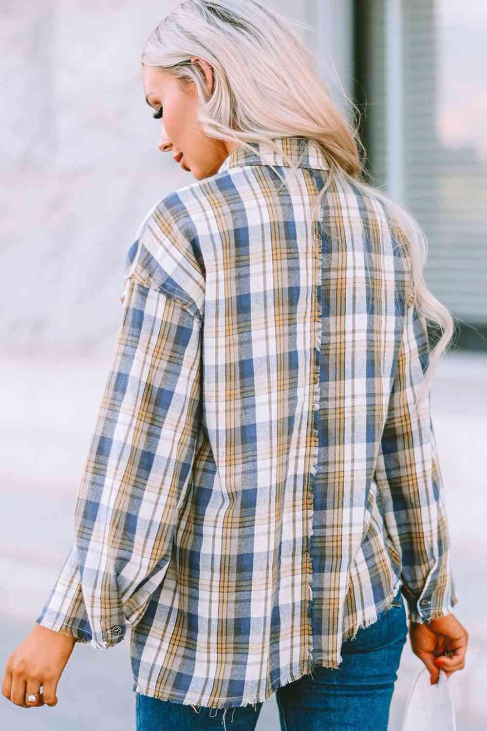 a woman walking down the street wearing a plaid shirt