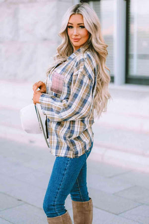 a woman wearing a plaid shirt and jeans