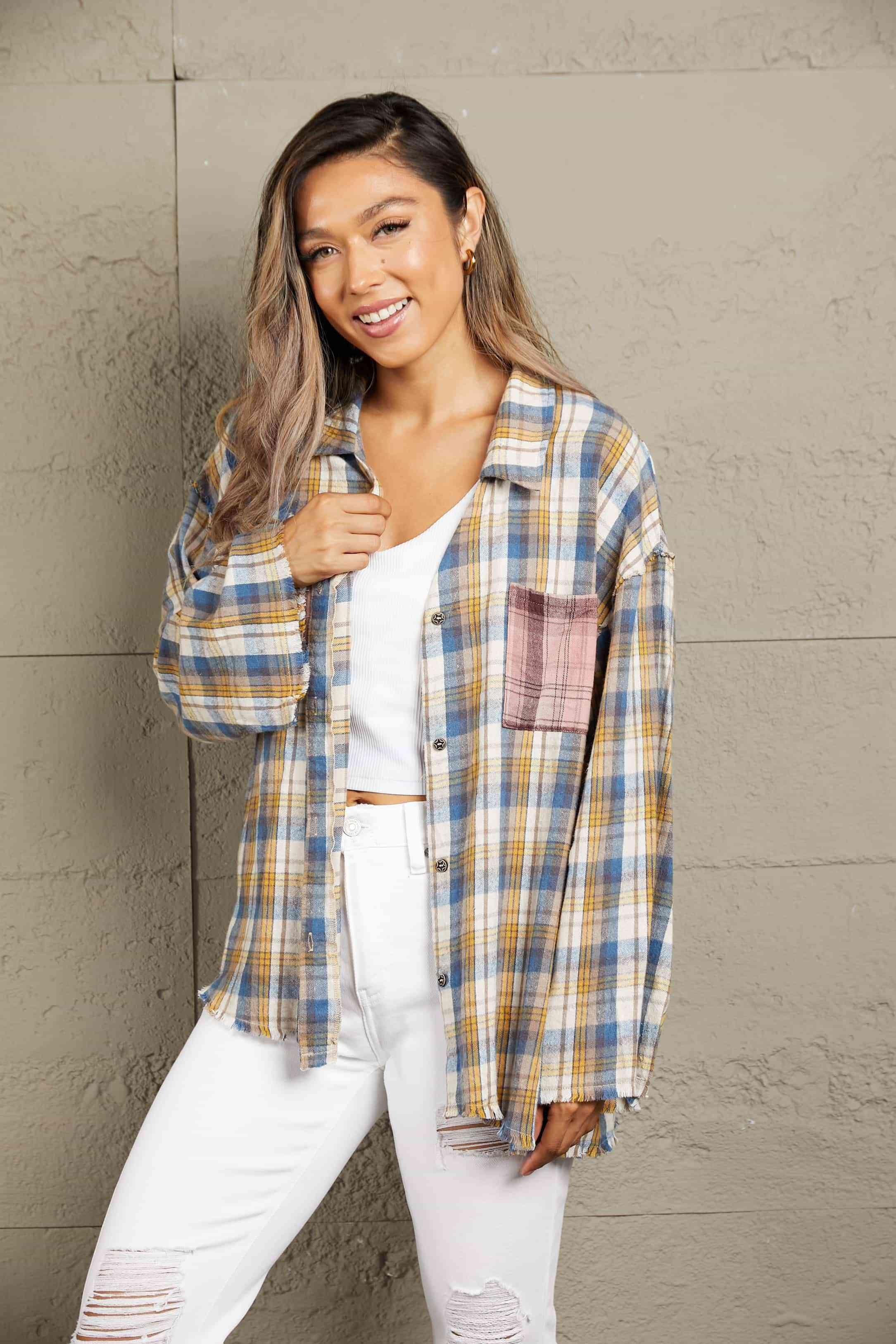 a woman wearing a plaid shirt and white jeans