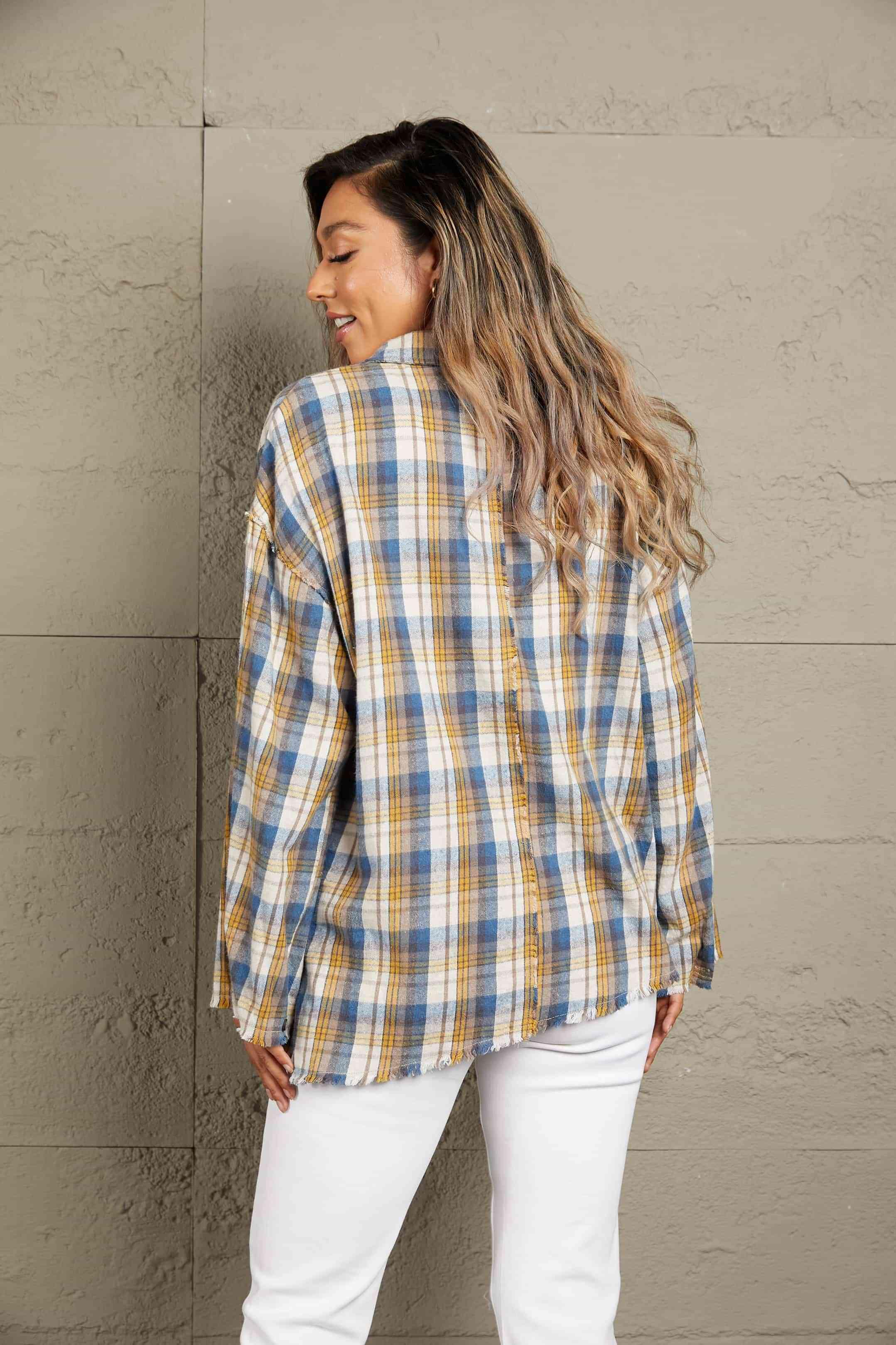 a woman wearing a yellow and blue plaid shirt