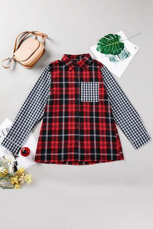 a red and black plaid shirt with a green leaf on it