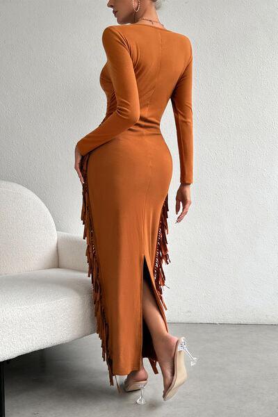 a woman in an orange dress standing next to a white couch