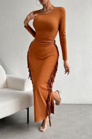 a woman in an orange dress posing for a picture