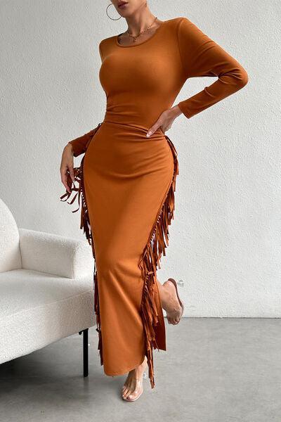 a woman in an orange dress posing for a picture