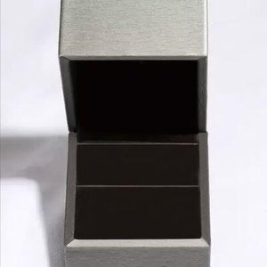 a metal box with two compartments on a white surface