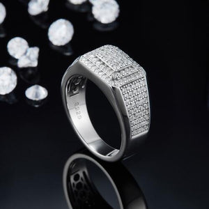 a ring with diamonds on a black surface