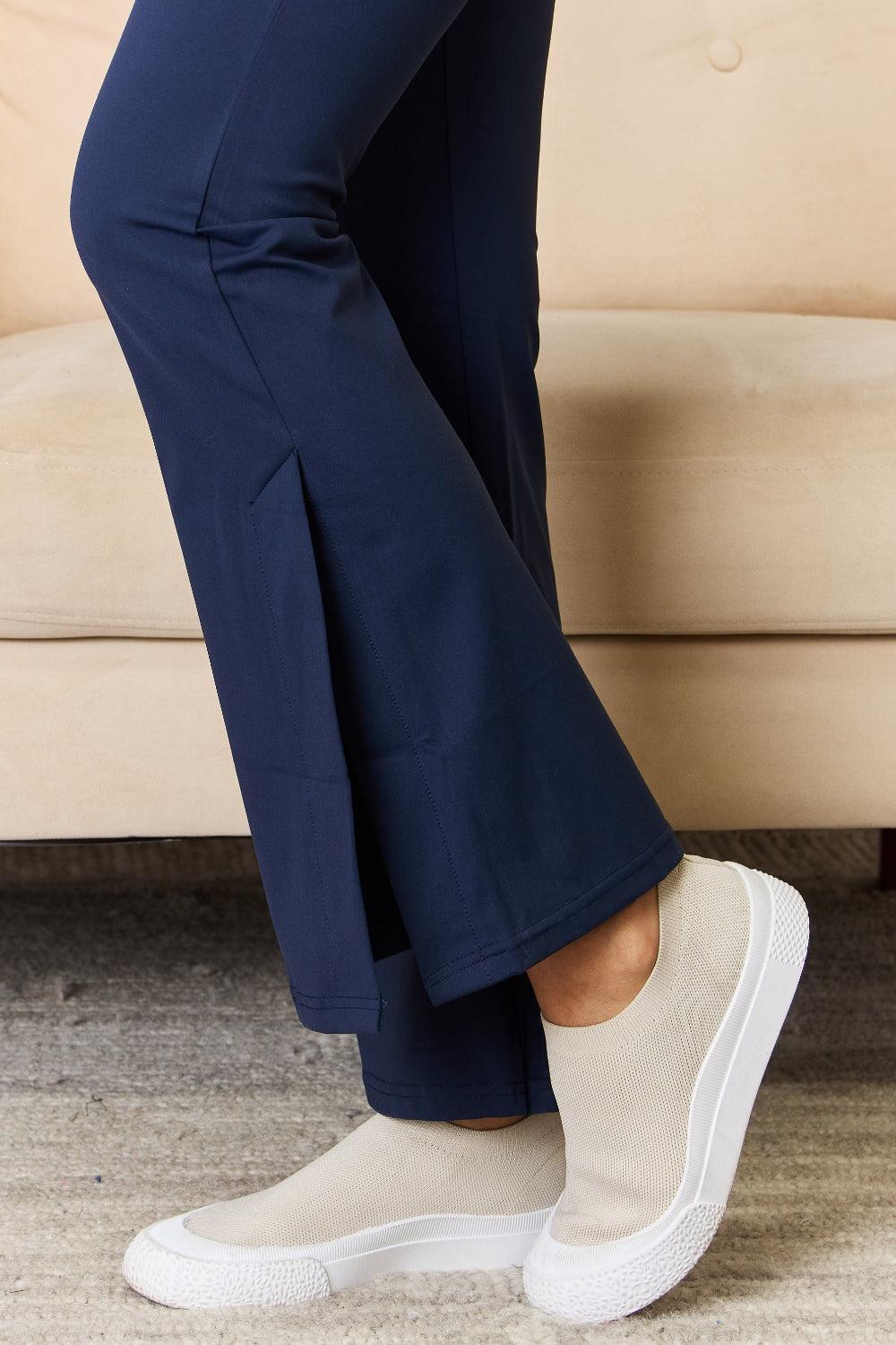 a woman in blue pants and white sneakers