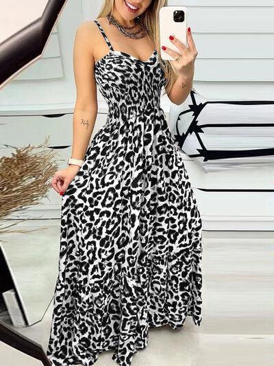 a woman taking a selfie in a leopard print dress