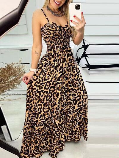 a woman taking a selfie in a leopard print dress