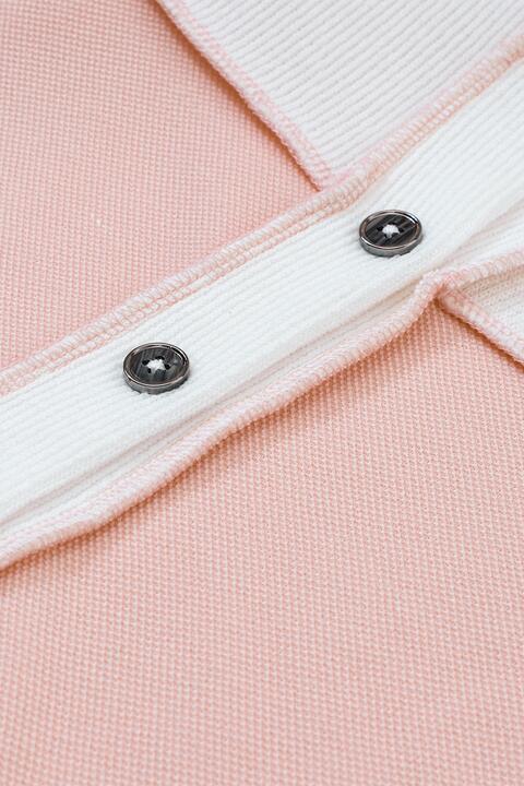 a close up of a pink and white sweater