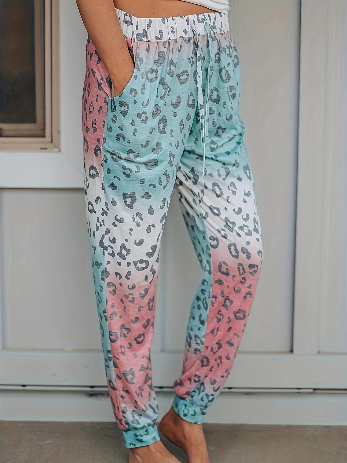 a woman standing in front of a door wearing a pair of leopard print pants