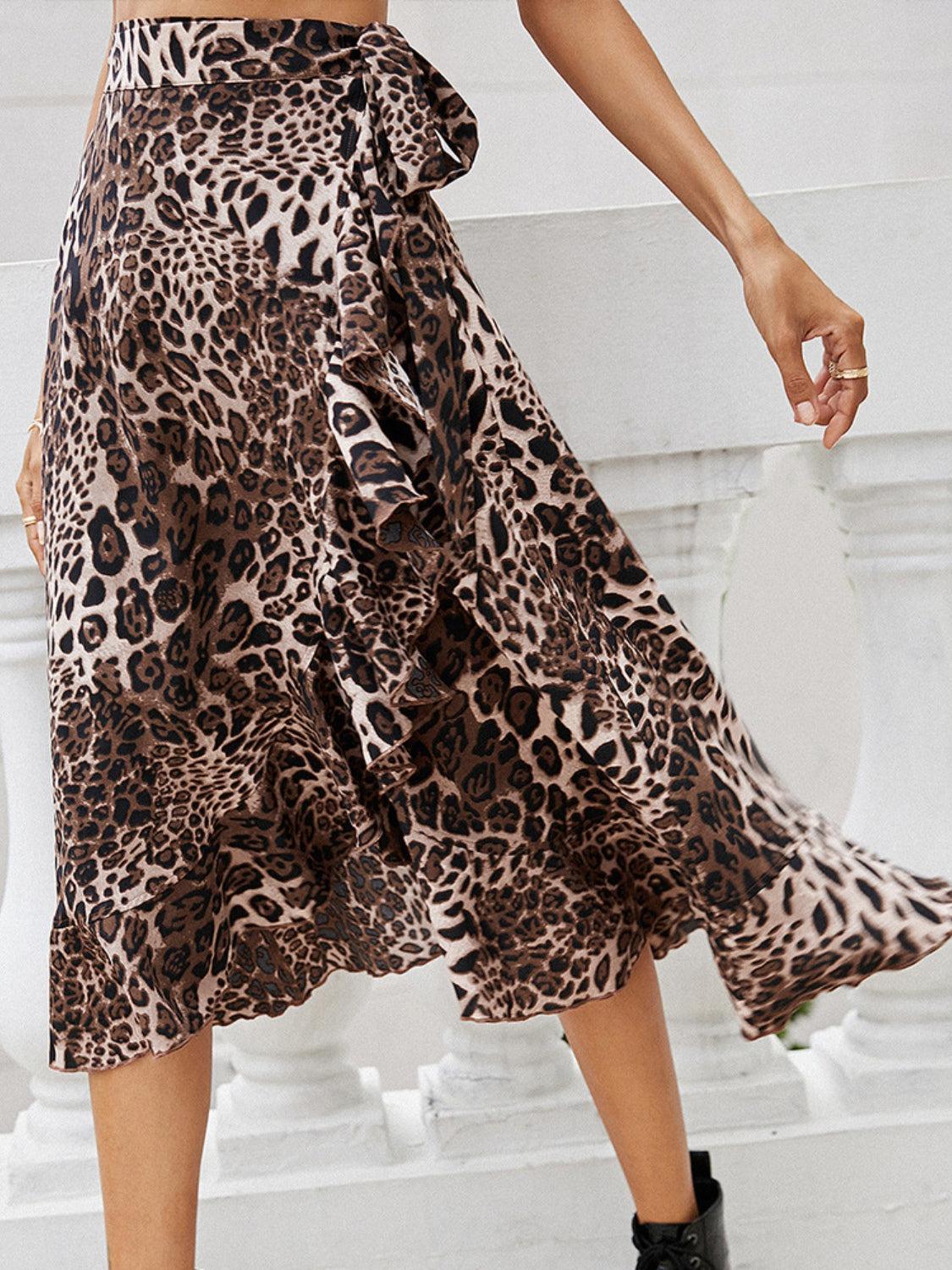 a woman in a leopard print skirt and black boots
