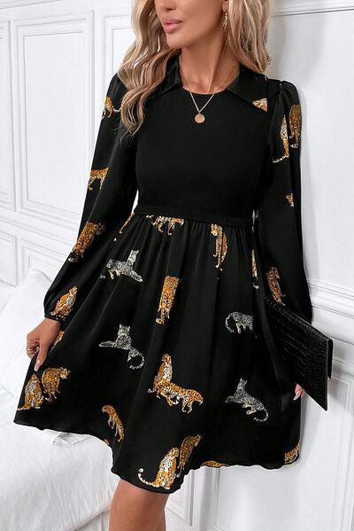 a woman wearing a black dress with gold horses on it