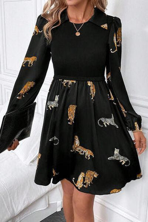 a woman in a black dress with tigers on it