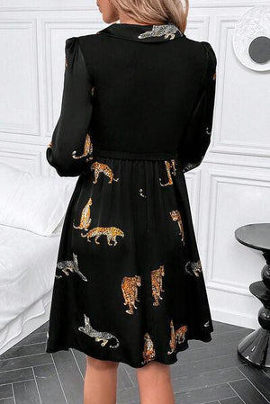 a woman wearing a black dress with tigers on it