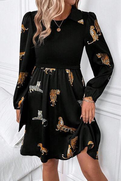 a woman wearing a black dress with a tiger print on it