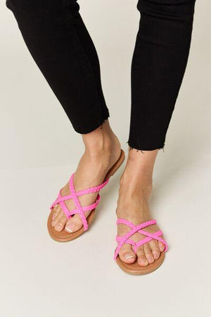 a woman in black pants and pink sandals