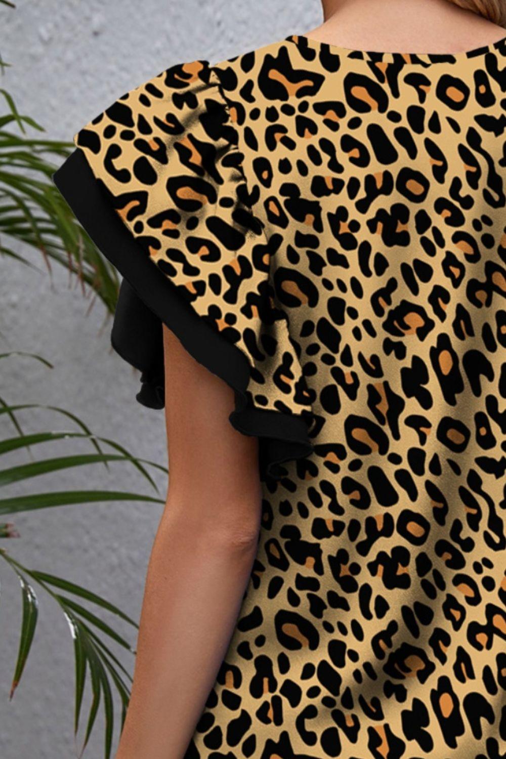 a woman wearing a leopard print top