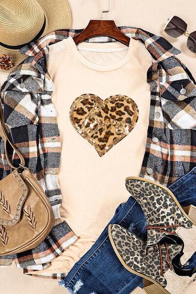 a white shirt with a leopard heart on it