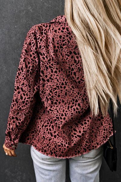 a woman with blonde hair wearing a leopard print shirt