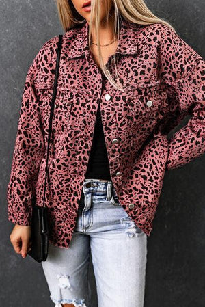 a woman wearing a pink leopard print jacket
