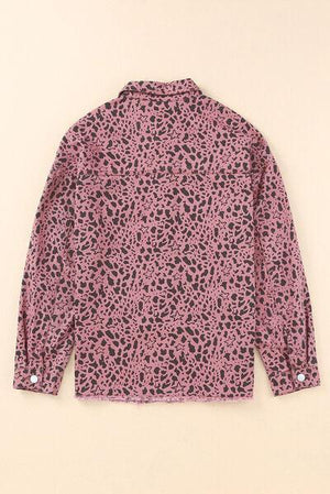 a pink shirt with black spots on it
