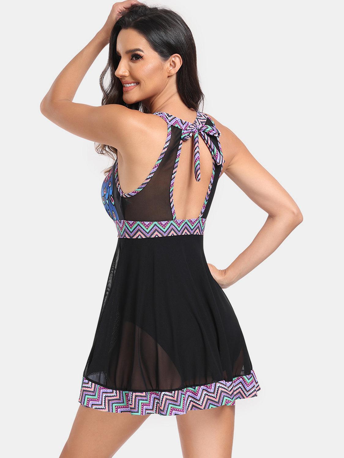 a woman wearing a black dress with a colorful print on the back