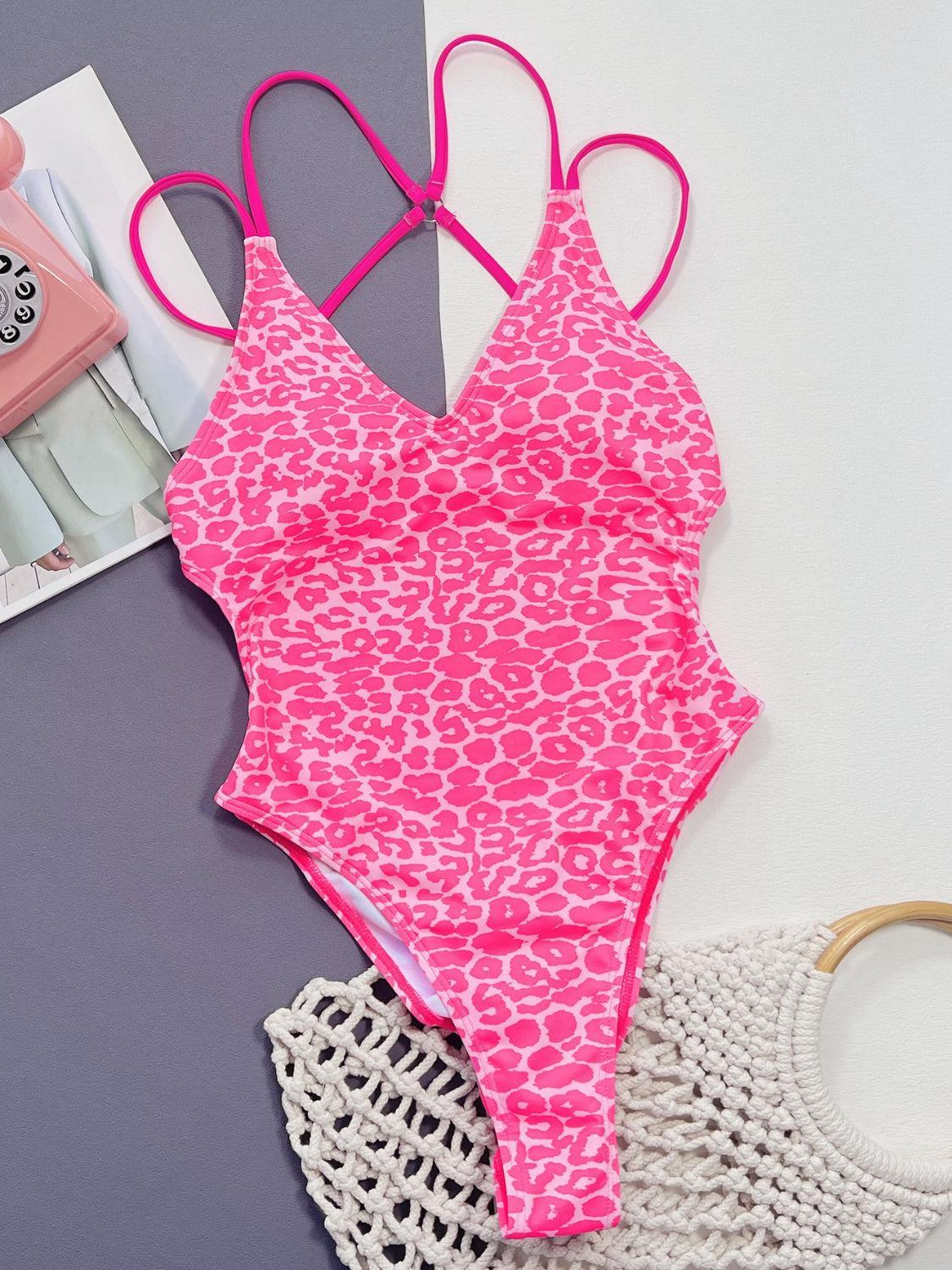 a pink and white swimsuit next to a magazine