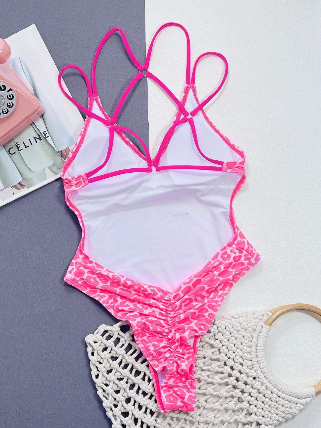 a pink and white bathing suit next to a magazine