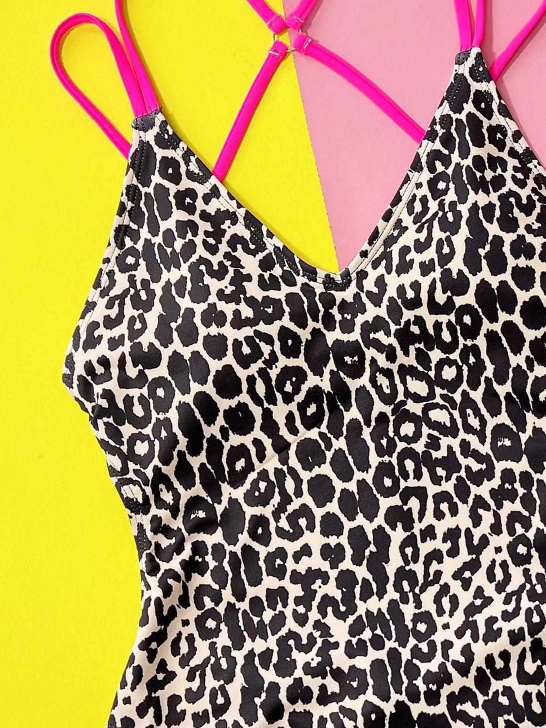 a leopard print dress with pink straps on a yellow and pink background