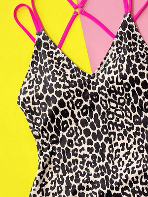 a leopard print dress with pink straps on a yellow and pink background